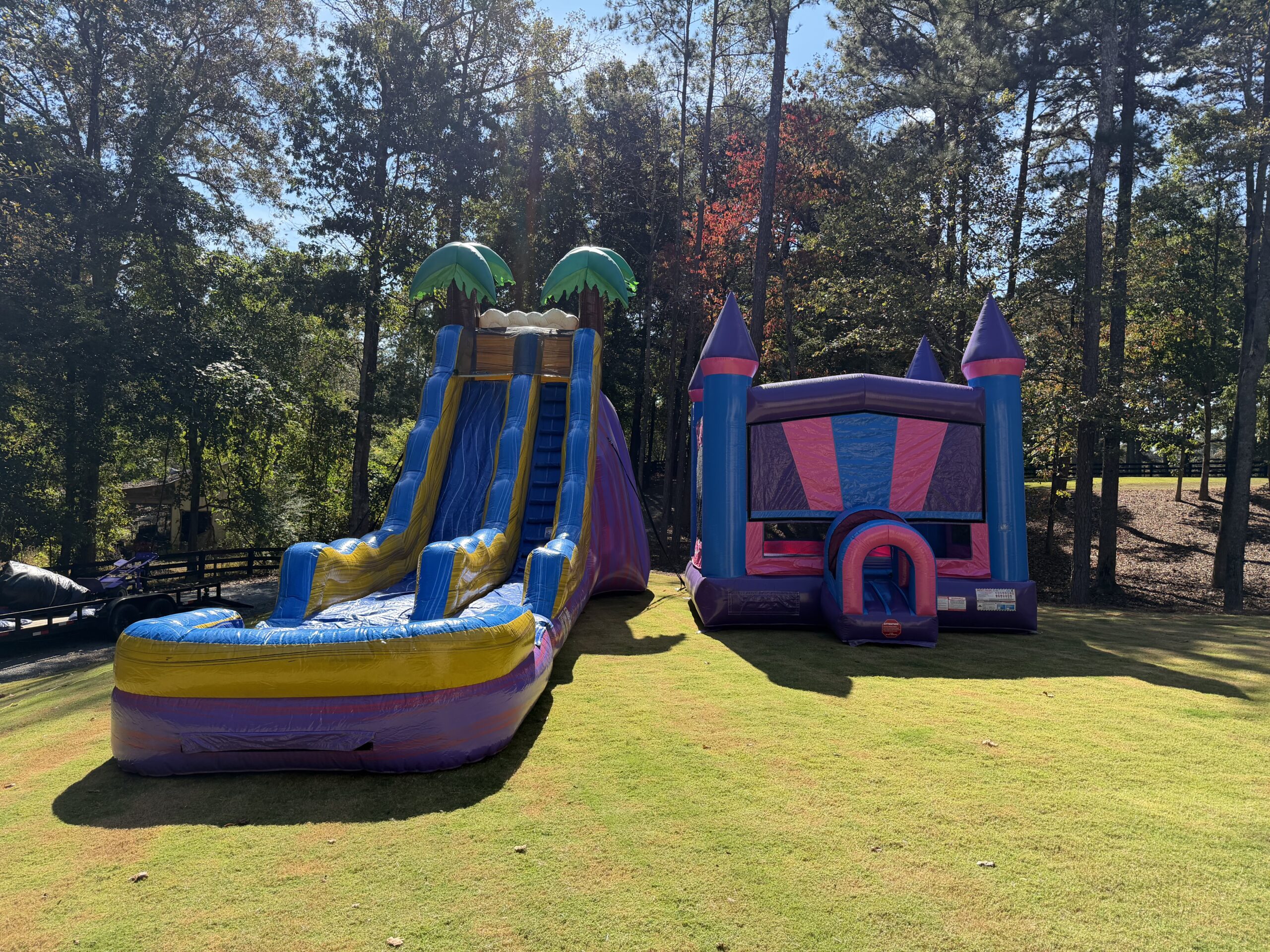 Pink bounce house and tropical water slide setup Marietta GA
