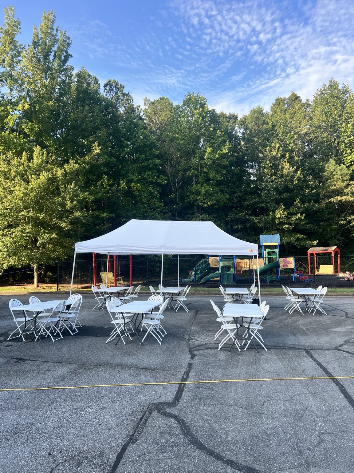 Complete event setup with tent, seating and inflatables