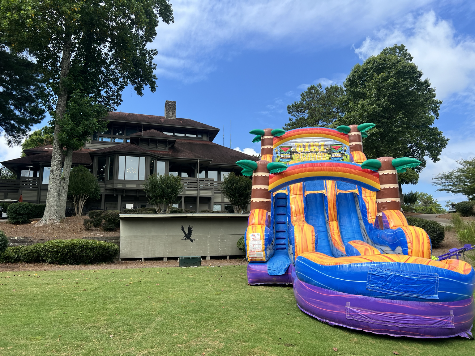 Inflatable attraction at Eagle Watch Golf Club with clubhouse in background