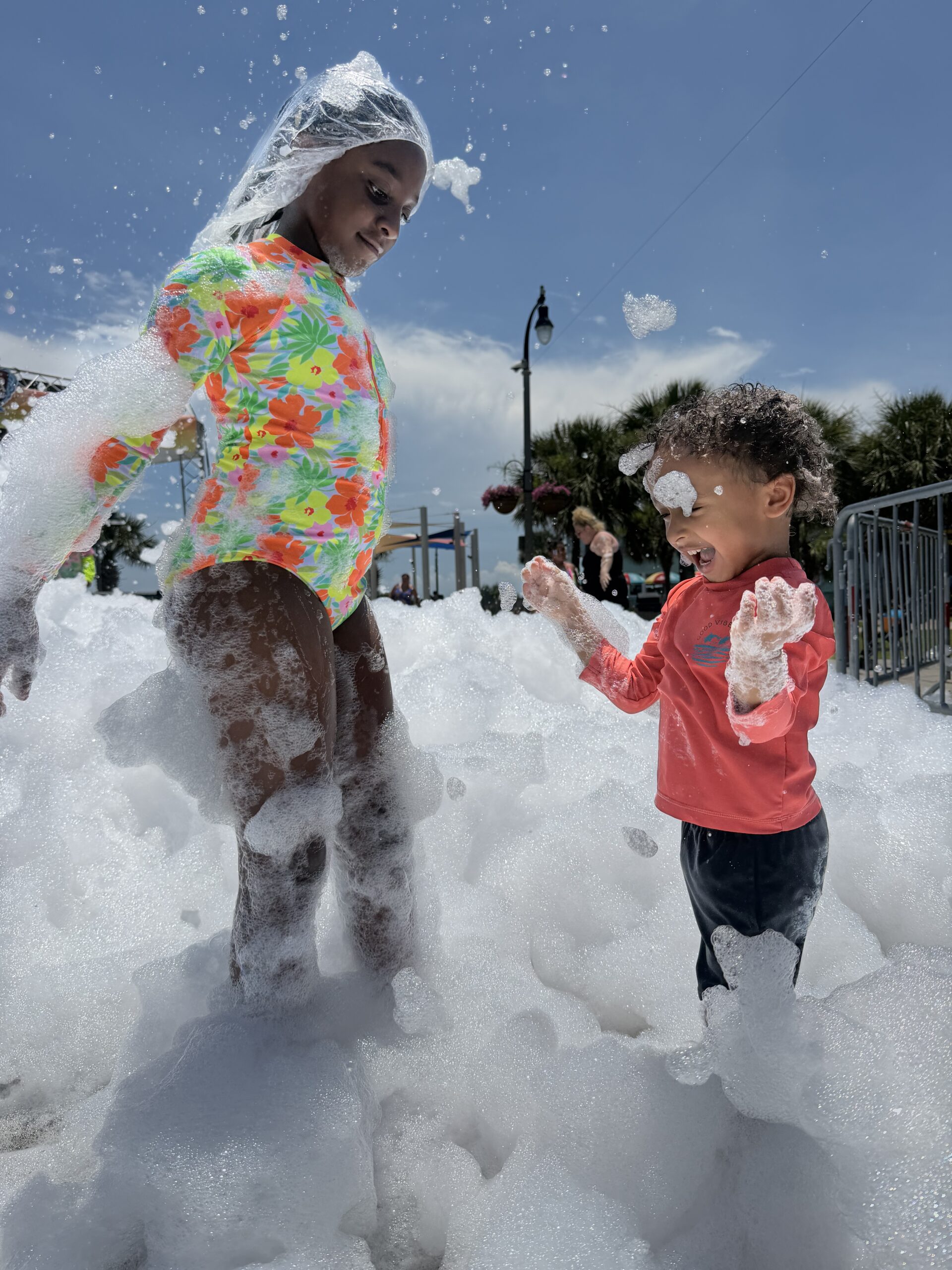 Kids playing at a foam party rental from Bounce House Woodstock at a community event