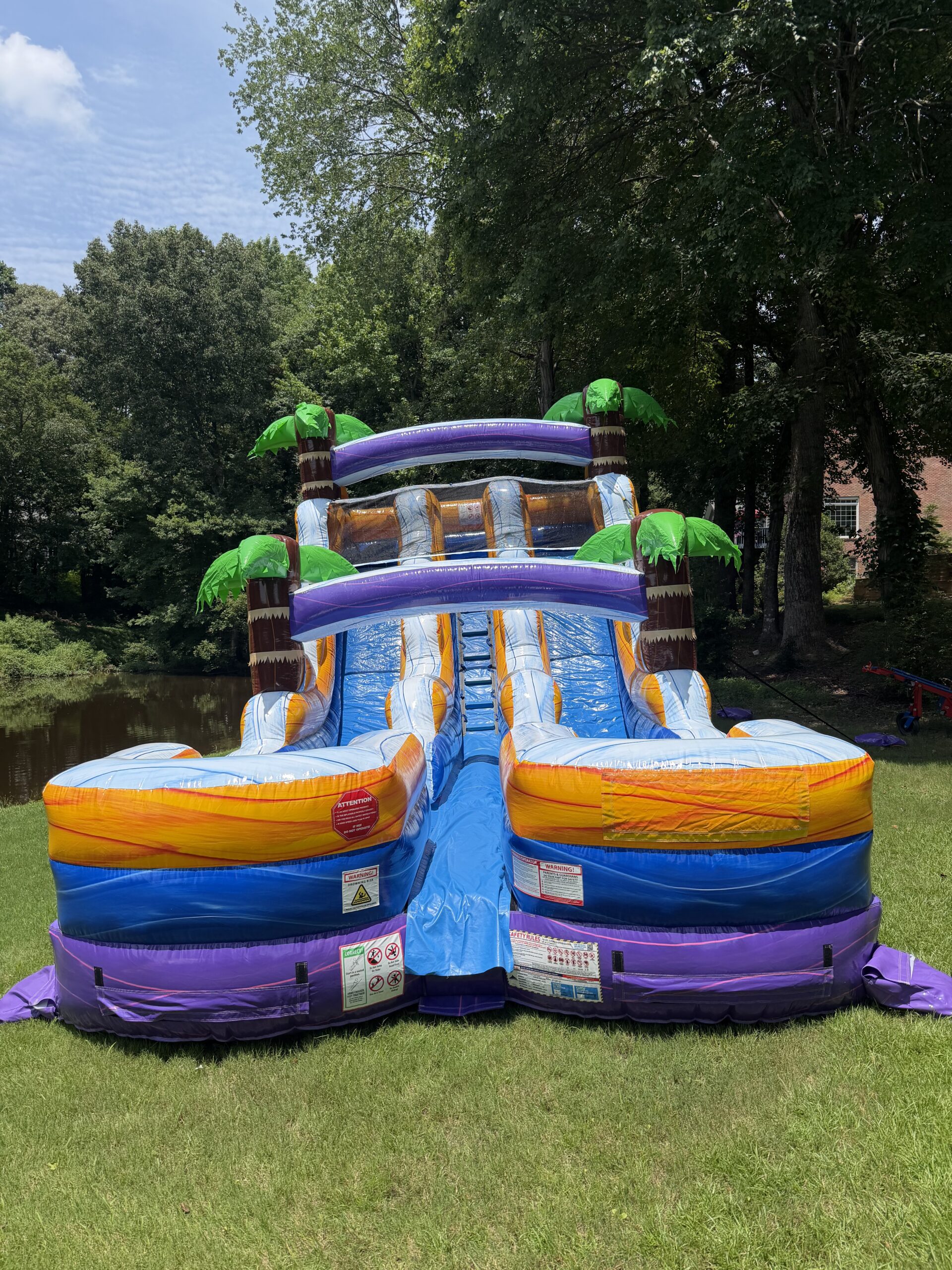 15 ft dual lane tropical purple water slide rental set up clean by Bounce House Woodstock in Woodstock GA