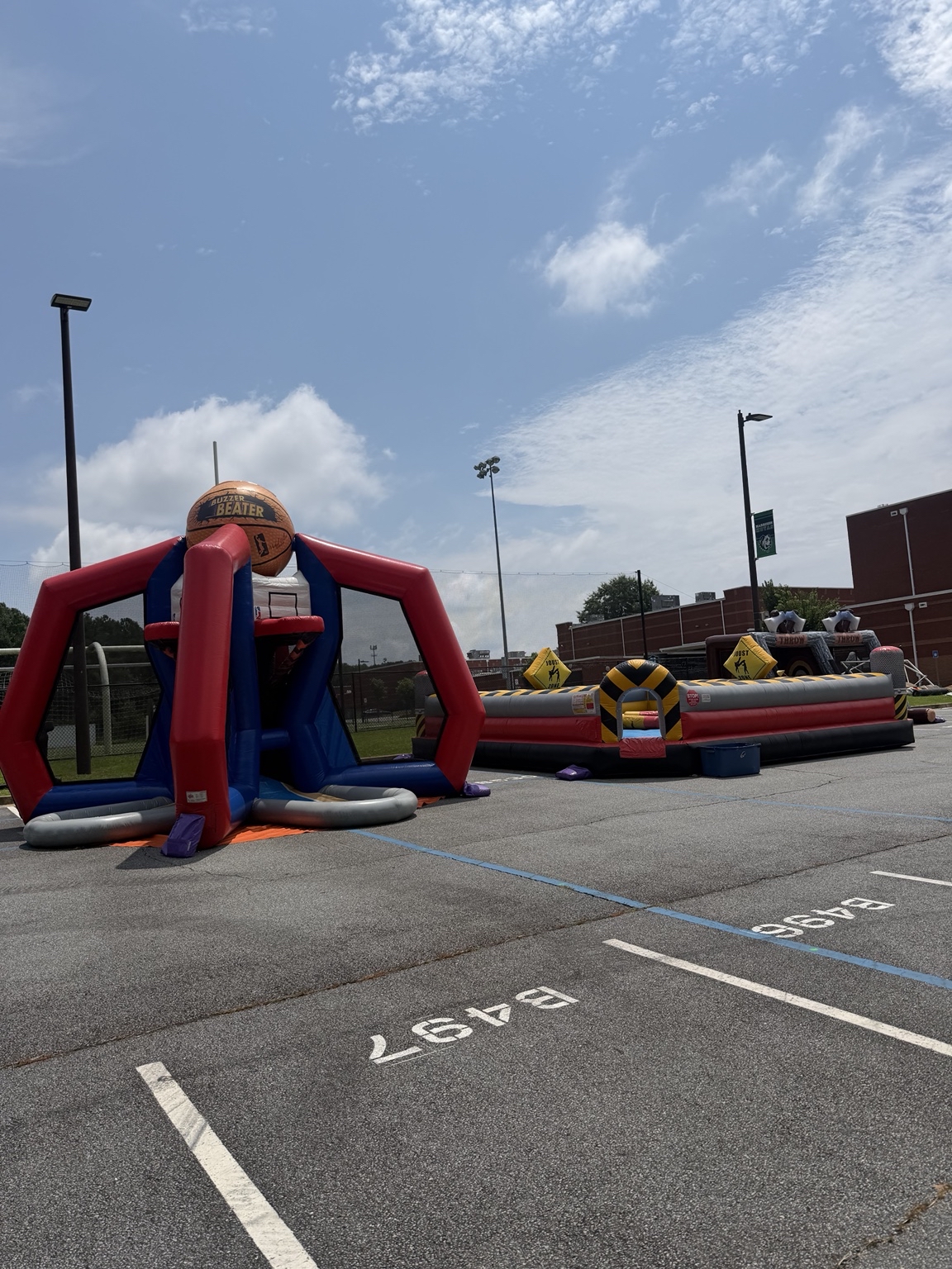 Buzzer Beater and joust inflatables at a school event