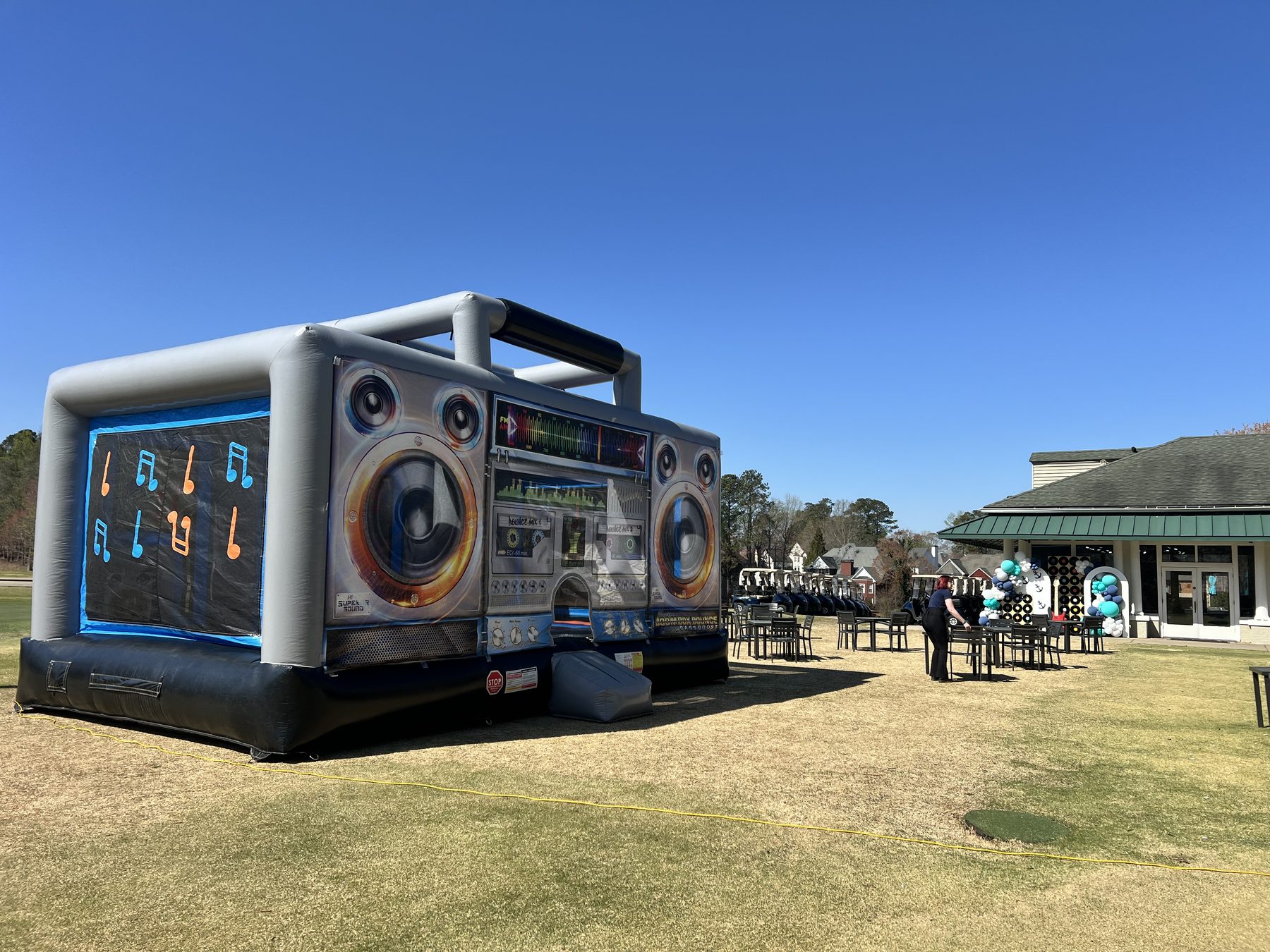 80s Boom Box jumbo bounce house professionally installed for an outdoor event