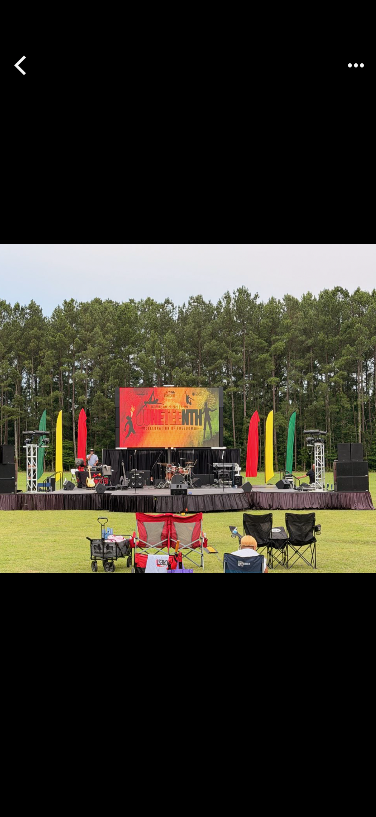 Outdoor stage and large LED screen at a community celebration
