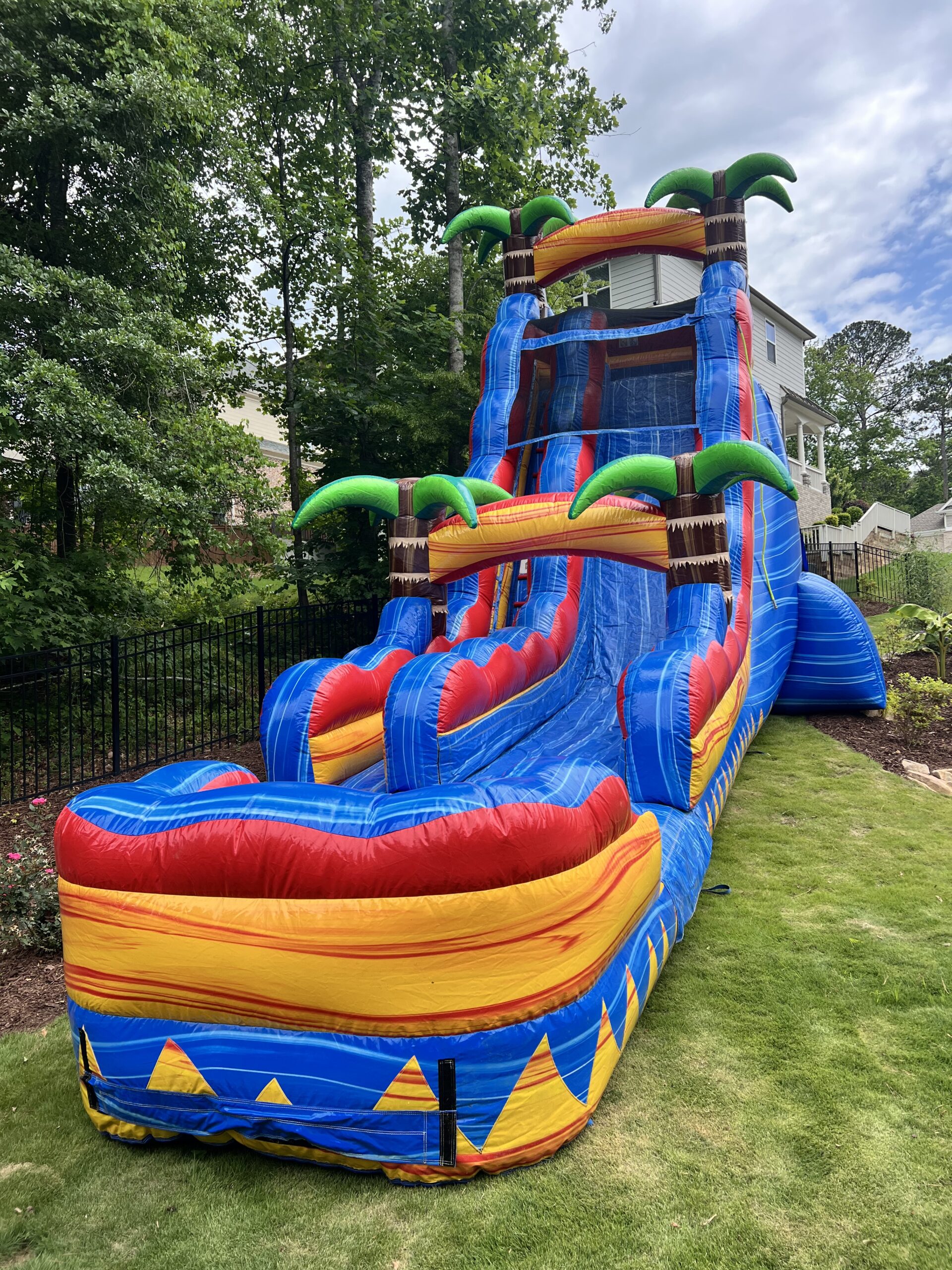 Live tropical dual-lane inflatable slide setup in Woodstock, Georgia