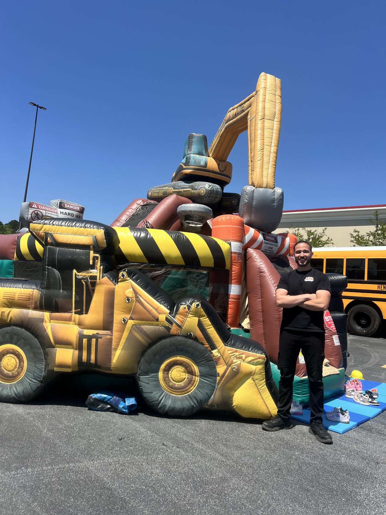 Construction-themed bounce and slide combo at a school event