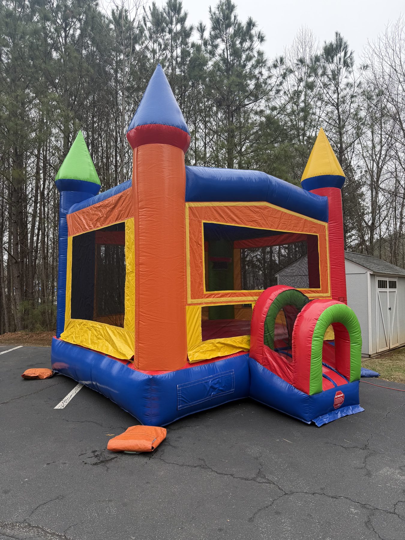 Kids rainbow castle bounce house professionally installed outdoors