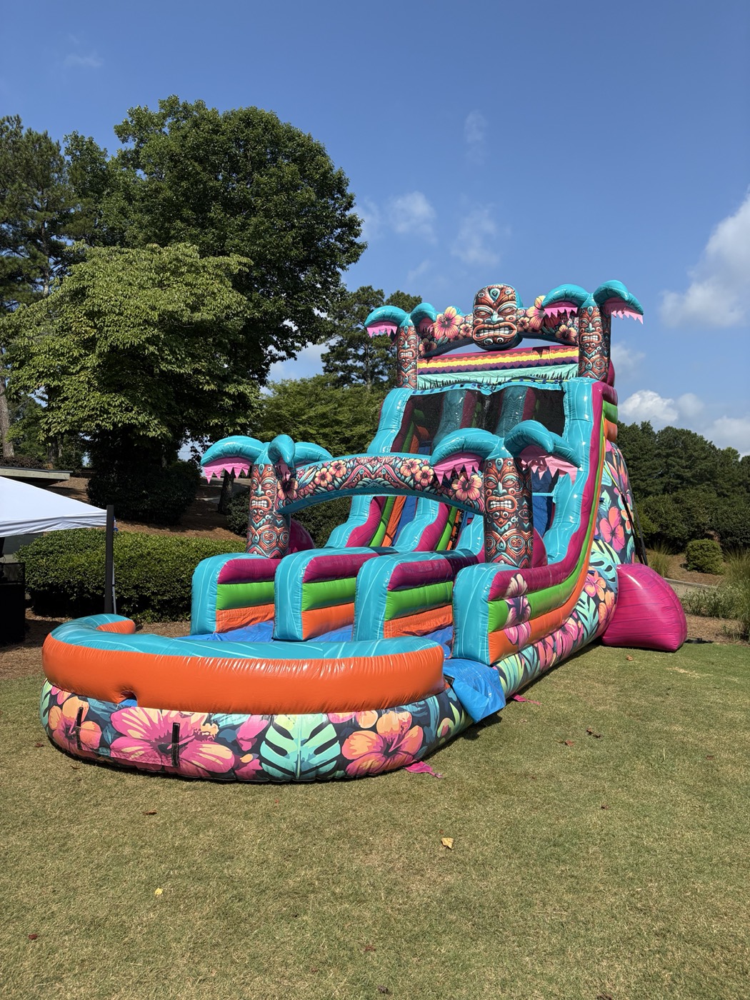Large tropical dual-lane water slide professionally installed on grass