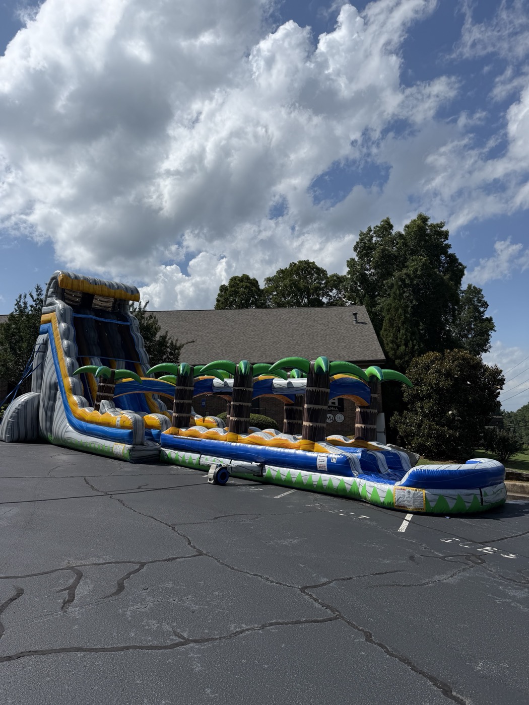 Large water slide setup outside a church for a community event